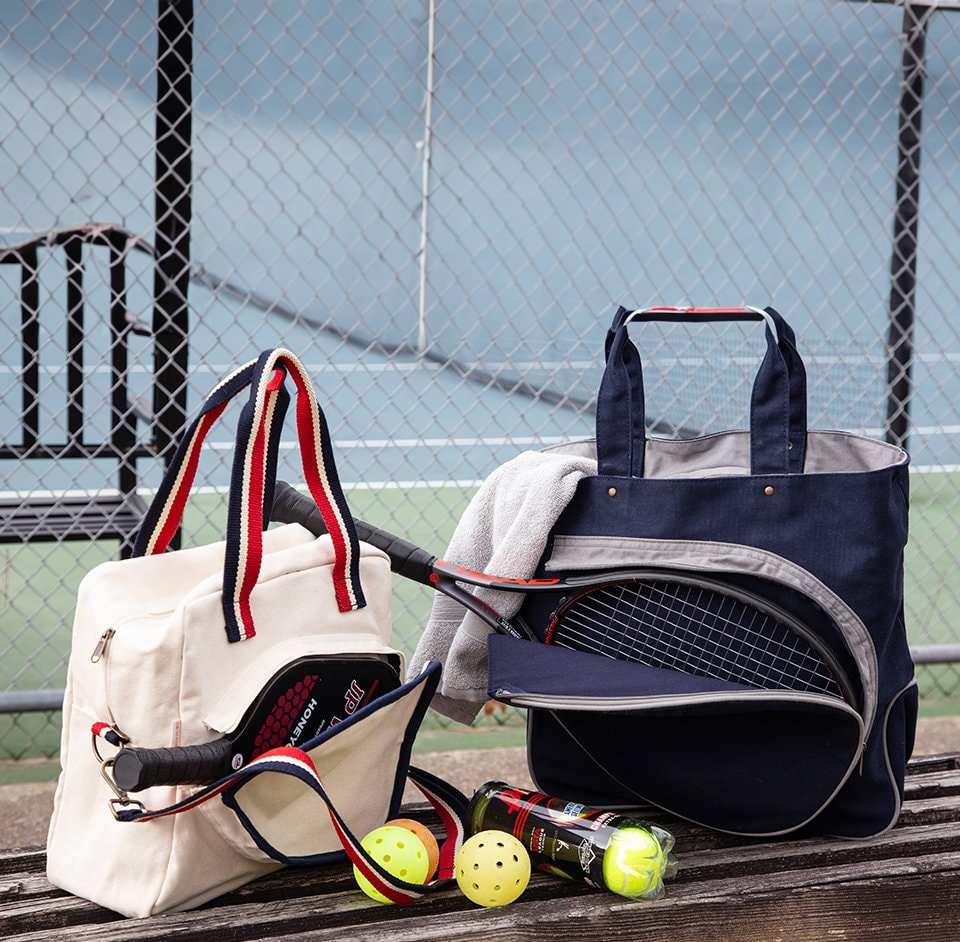 Pickleball bags at pickleball court with paddles